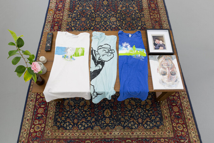 Image detail of table with collection of personal objects, LED TV Screen in the backgroud