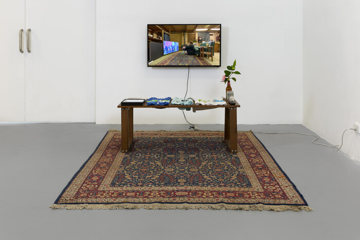 Image of table with collection of personal objects, LED TV Screen in the backgroud